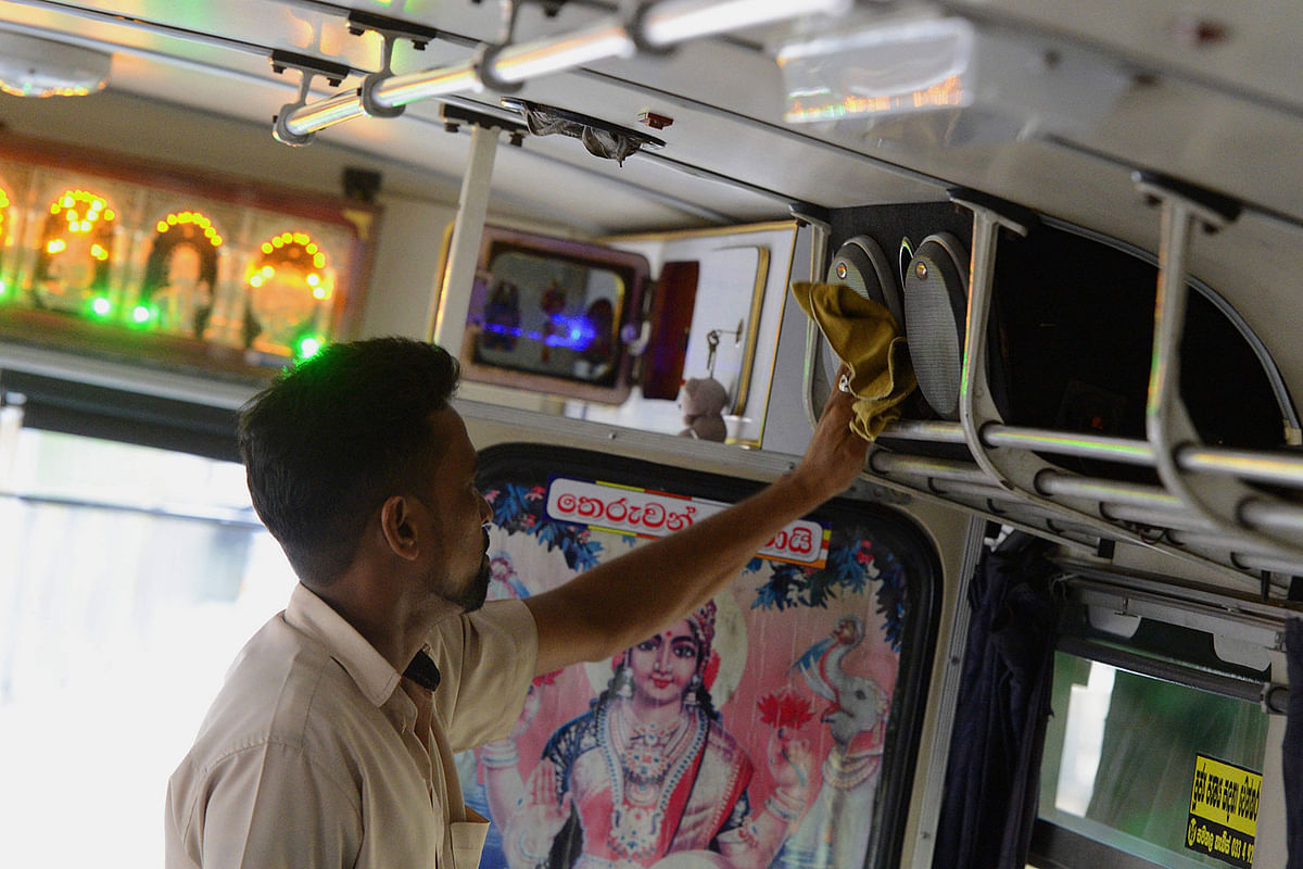 A man cleans the speakers of a bus in Biyagama on 2 January 2020. Photo: AFP Tags: Sri Lanka, bus
