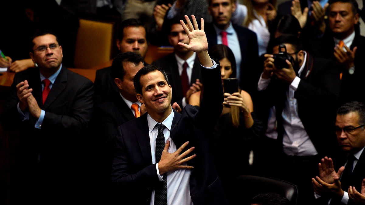 In this file picture taken on 5 January 2019 the incoming president of Venezuela`s National Assembly Juan Guaido (C) waves upon arriving for the inauguration ceremony in Caracas. Photo: AFP
