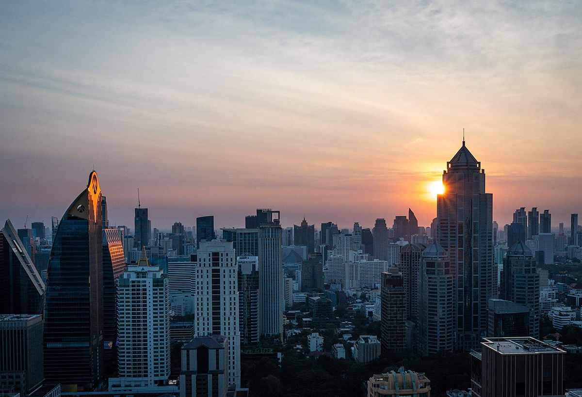 The sun is seen over the skyline of Bangkok during the first sunrise of the new decade on 1 January, 2020. Photo: AFP