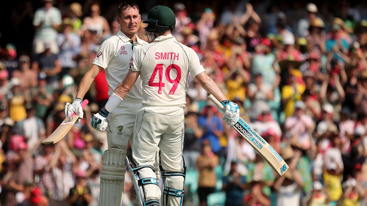 Australia’s Marnus Labuschagne (L) celebrates scoring a century (100 runs) with Steve Smith during the first day of the third cricket Test match between Australia and New Zealand at the Sydney Cricket Ground in Sydney on 3 January 2020. Photo: AFP
