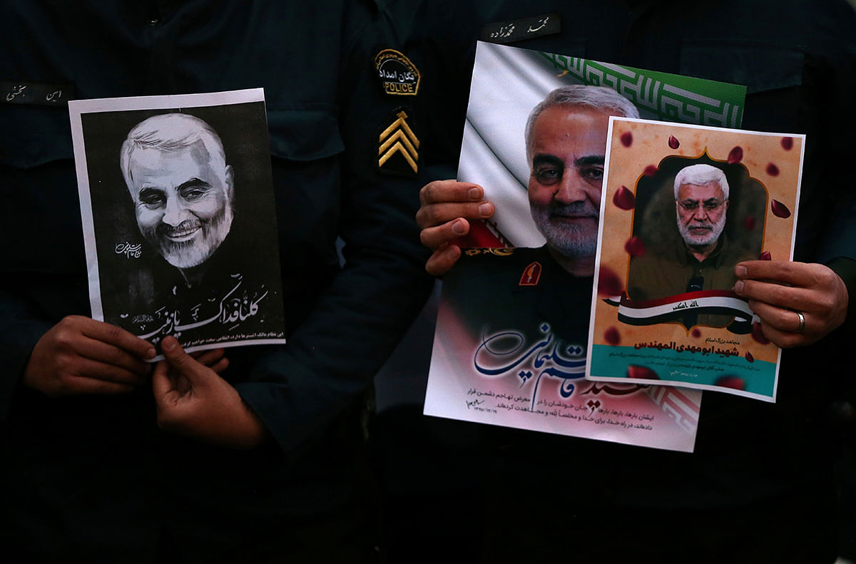 Iranian guards hold a picture of the late Iranian major-general Qassem Soleimani, during a protest against the assassination of Soleimani, head of the elite Quds Force, and Iraqi militia commander Abu Mahdi al-Muhandis, who were killed in an air strike at Baghdad airport, in front of United Nation office in Tehran, Iran 3 January, 2020. Photo: Reuters