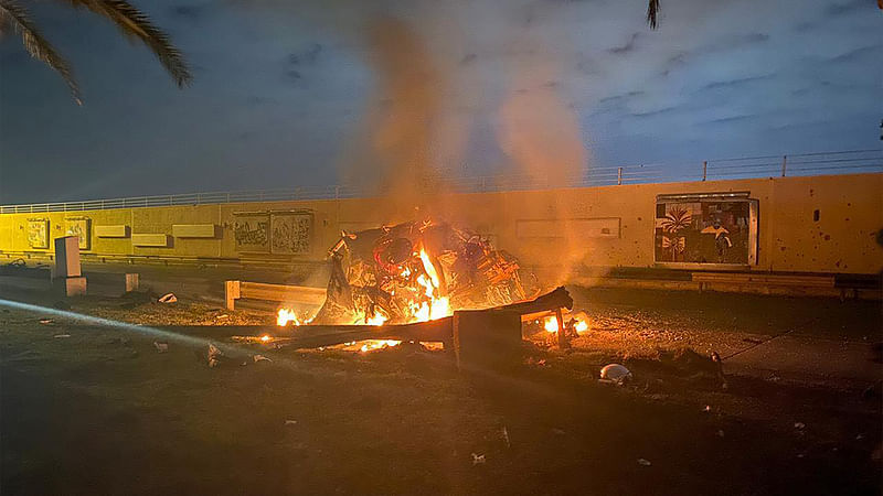 A picture published by the media office of the Iraqi military`s joint operations forces on their official Facebook page shows a destroyed vehicle on fire following a US strike on 3 January 2020 on Baghdad international airport road in which top Iranian commander Qasem Soleimani was killed along with eight others, including the deputy head of Iraq`s powerful Hashed al-Shaabi paramilitary force. Photo: AFP