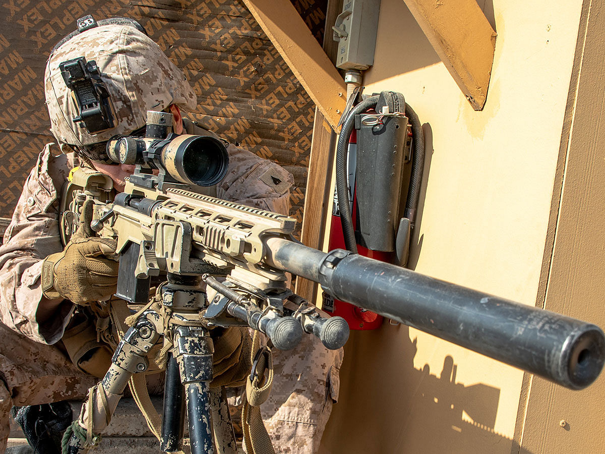 A US Marine with 2nd Battalion, 7th Marines, assigned to the Special Purpose Marine Air-Ground Task Force-Crisis Response-Central Command (SPMAGTF-CR-CC) 19.2, looks through the scope of a M110 Semi-Automatic Sniper System (SASS) at the US embassy compound in Baghdad, Iraq, on 3 January 2020. Photo: Reuters
