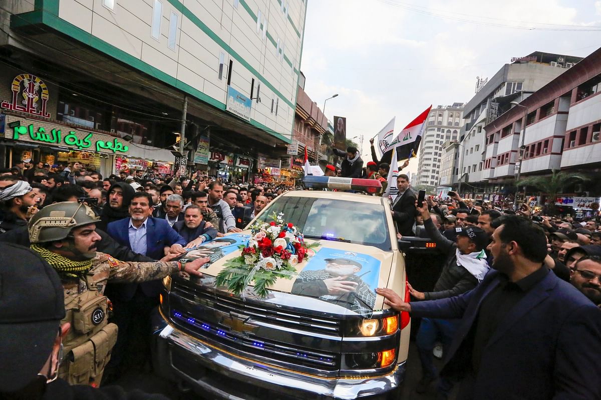 This handout picture released by Iraq`s Hashed al-Shaabi paramilitary force shows a scene from the funeral procession for slain Iranian military commander Qasem Soleimani and Iraqi paramilitary chief Abu Mahdi al-Muhandis (portrait) just outside Baghdad`s high-security Green Zone on 4 January, 2020. Photo: AFP