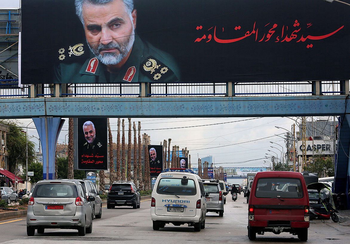 Vehicles pass near a picture of late Iranian Major-General Qassem Soleimani, head of the elite Quds Force, in Beirut`s suburbs. Photo: Reuters