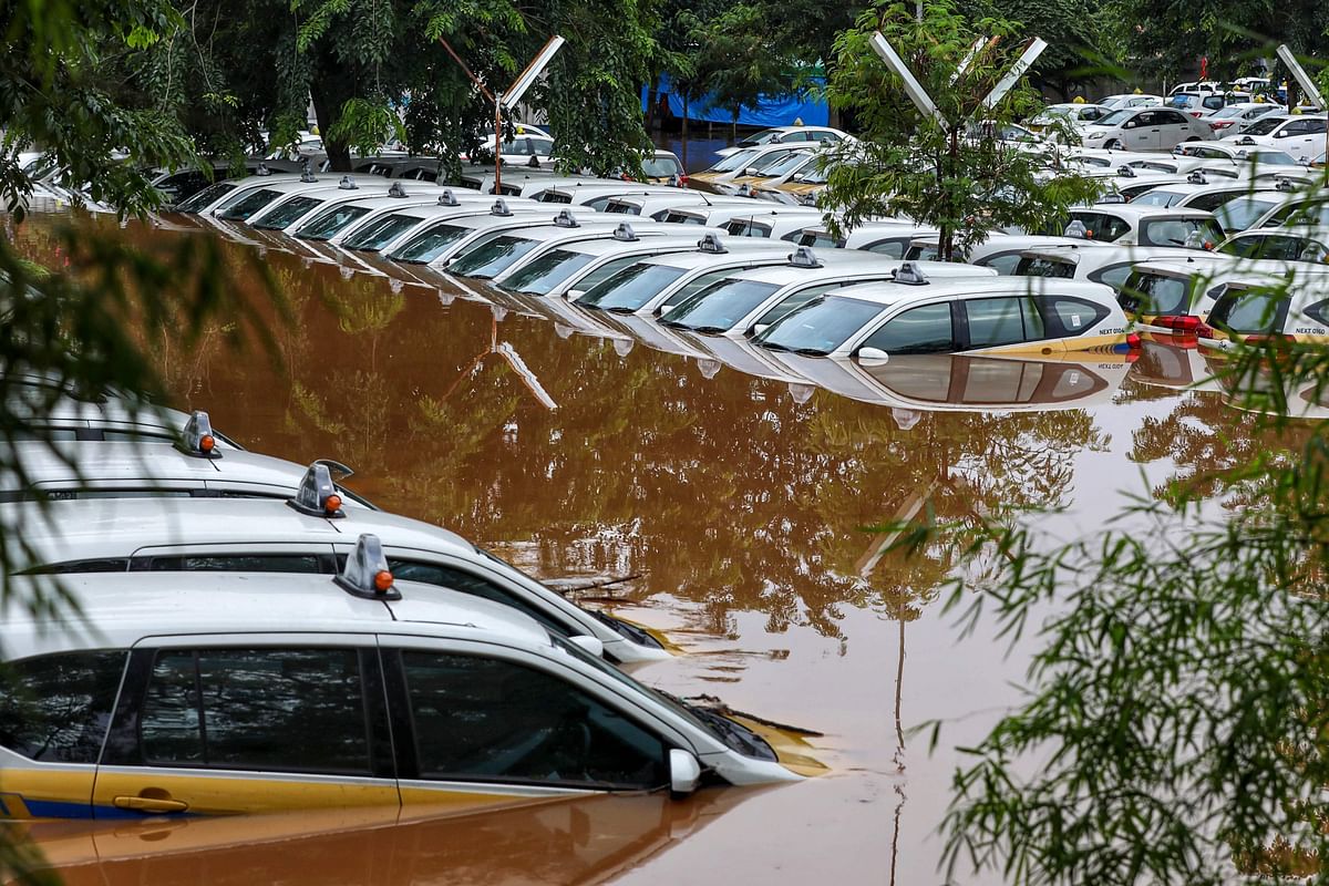 A fleet of flooded taxis are seen at the operator`s submerged parking lot following overnight rain in Jakarta on 1 January 2020. Nine people died after Indonesia`s capital was hit by its deadliest flooding in years, authorities said 1 January, as torrential rains on New Year`s Eve left vast swathes of the megalopolis submerged. Photo: AFP