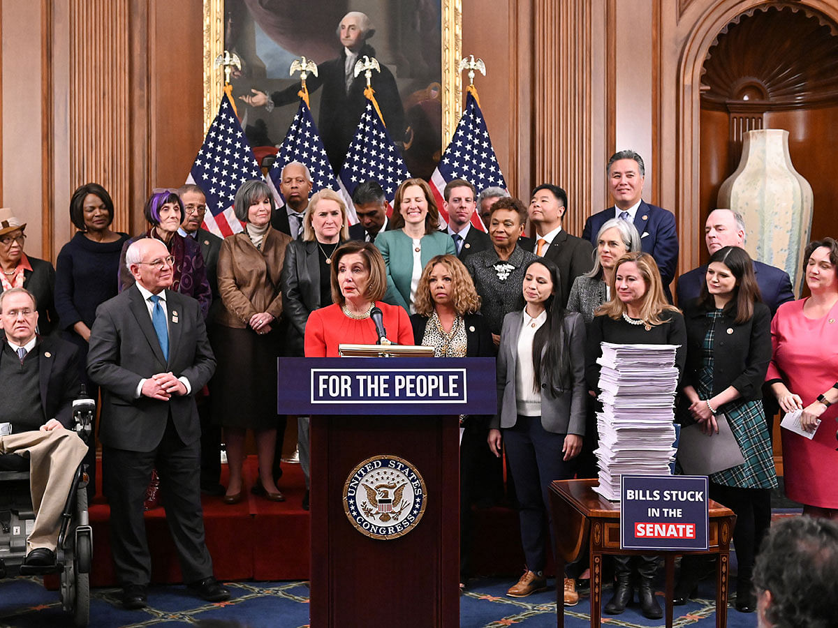 Speaker of the House Nancy Pelosi, joined by fellow Democrats, speaks next to a stack of legislation passed by the House during a news conference at the Capitol in Washington, US, on 19 December 2019. Photo: Reuters