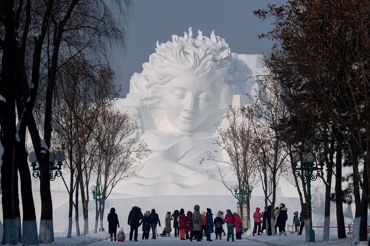 Tourists walk in front of an ice sculpture ahead of the opening of the Harbin International Snow and Sculpture Festival in Harbin, in China`s northeast Heilongjiang province on 4 January 2020. Photo: AFP