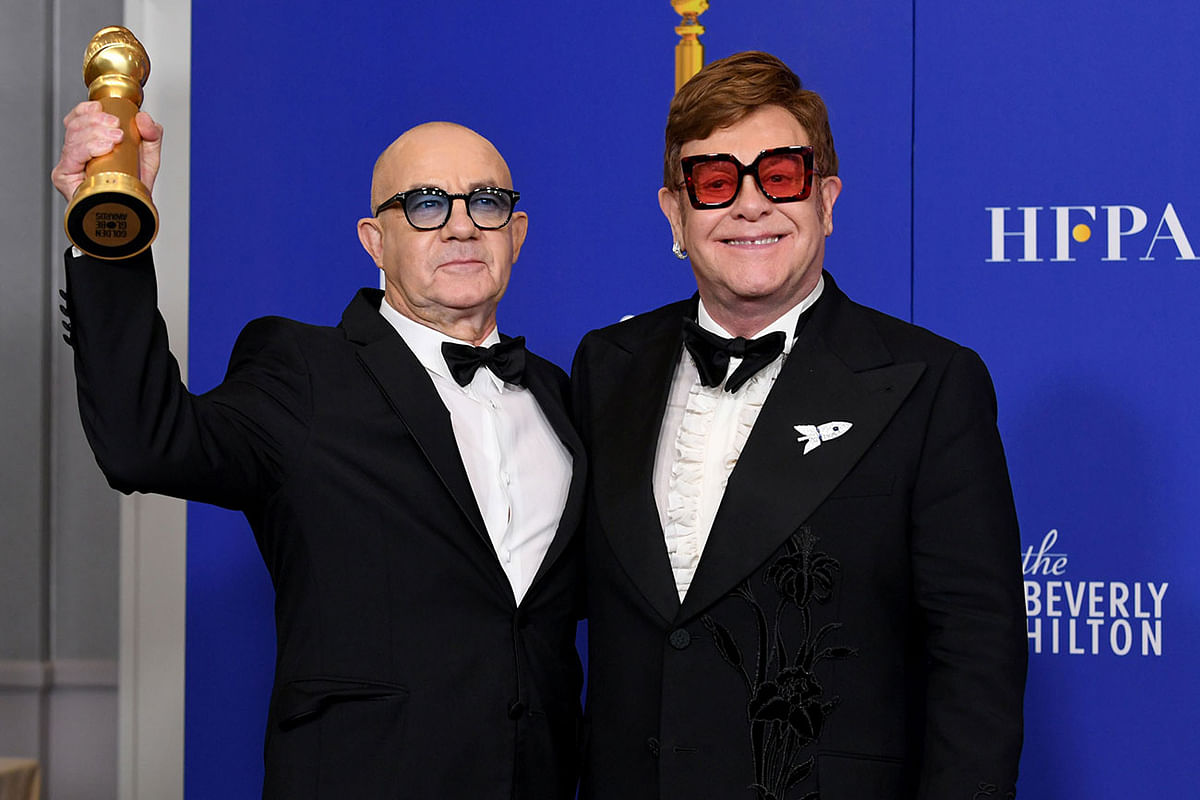 British composer Bernie Taupin (L) and British musician Elton John pose in the press room with the award for Best Original Song - Motion Picture during the 77th annual Golden Globe Awards on 5 January at The Beverly Hilton hotel in Beverly Hills, California. Photo: AFP