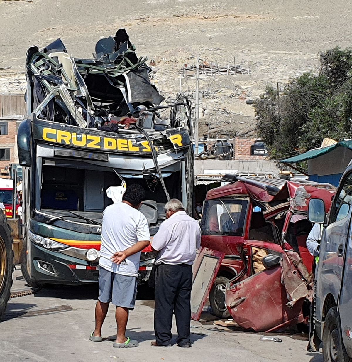 At least 14 people were killed and 40 others injured after a bus crashed into parked cars in the south of Peru, police said on Monday Cap: Men look at a a double-decker bus that crashed into parked cards on the Pan American Highway in the Arequipa region, southern Peru, on early 6 January 2020. Photo: AFP