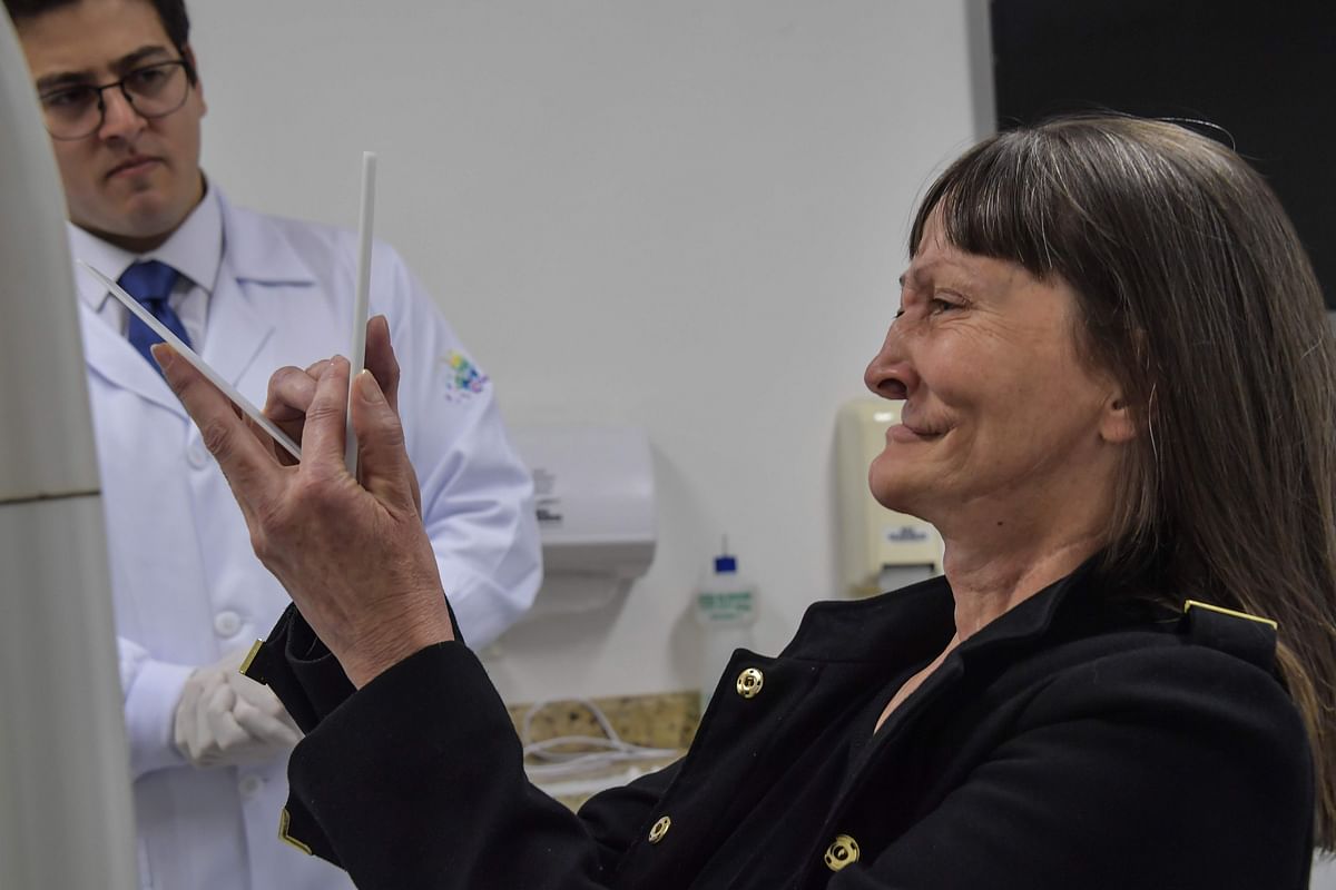 Denise Vicentin, who lost her right eye and part of her jaw to cancer, cries when she looks in the mirror for the first time after getting a digitally-engineered prosthesis, in Sao Paulo, Brazil, on 3 December 2019. Photo: AFP