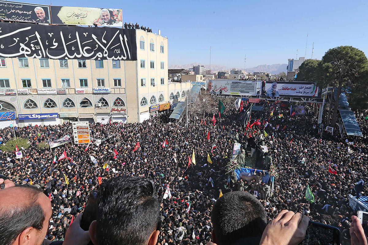 Iranian mourners gather around a vehicle carrying the coffin of slain top general Qasem Soleimani during the final stage of funeral processions, in his hometown Kerman on 7 January 2020. Photo: AFP