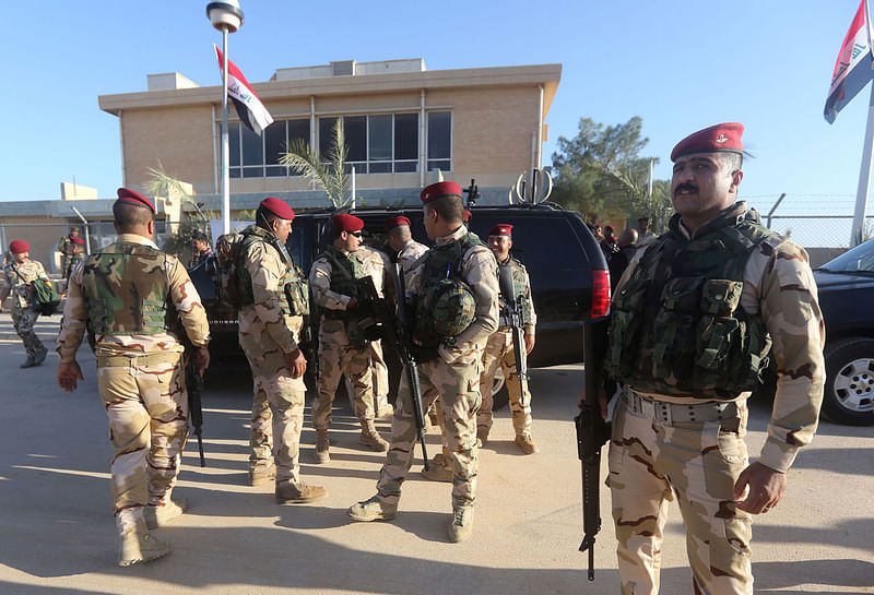 In this file photo taken on 11 November 2014 Iraqi army soldiers stand before a conference on fighting the Islamic State group attended by Iraq`s tribal leaders, militiamen and members of the government, at the Al-Asad air base, in Iraq`s Anbar province. Photo: AFP