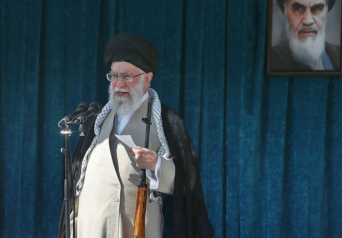 This file handout picture provided by the Iranian supreme leader office on 5 June 2019 shows the Islamic republic`s supreme leader, Ayatollah Ali Khamenei, holding a rifle as he delivers the Eid al-Fitr sermon during prayers at the Imam Khomeini Mausoleum in Tehran to mark the end of the Muslim fasting month of Ramadan, with a portrait of his predecessor, the late Ayatollah Ruhollah Khomeini hanging on the wall behind him. Khamenei vowed `severe revenge` after the United States killed the commander of the Islamic republic`s Quds Force, General Qasem Soleimani, in Baghdad on 3 January 2020. Photo: AFP