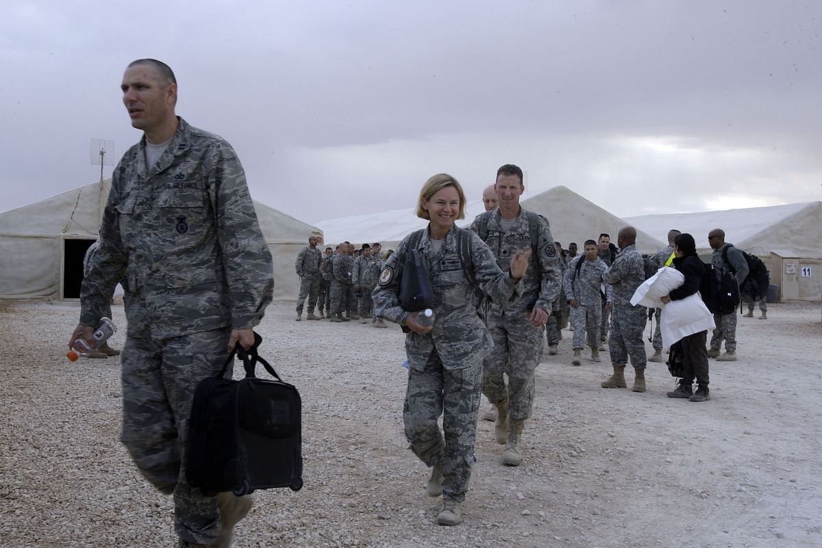 In this file photo taken on 1 November, 2011, a US army soldier waves as her regiment prepares to fly out of Iraq on their way home from the al-Asad Air Base in Iraq`s Anbar province