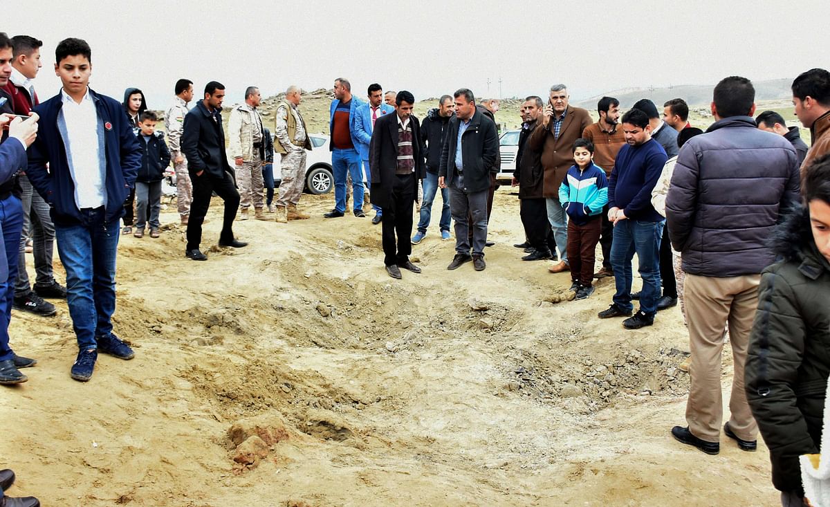 Iraqi Kurds inspect a crater caused by a reportedly Iranian missile initially fired at Iraqi bases housing US and other US-led coalition troops, in the Iraqi Kurdish town of Bardarash in the Dohuk governorate on 8 January. Photo: AFP