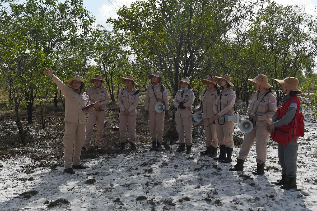 This picture taken on 6 January 2020 shows members of an all-female demining group having a team briefing at a landmine site in the Trieu Phong district in Quang Tri province. Photo: AFP