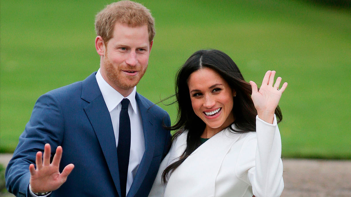 In this file photo taken on 27 November 2017 Britain`s Prince Harry and his fiancée US actress Meghan Markle pose for a photograph in the Sunken Garden at Kensington Palace in west London, following the announcement of their engagement. Photo: AFP