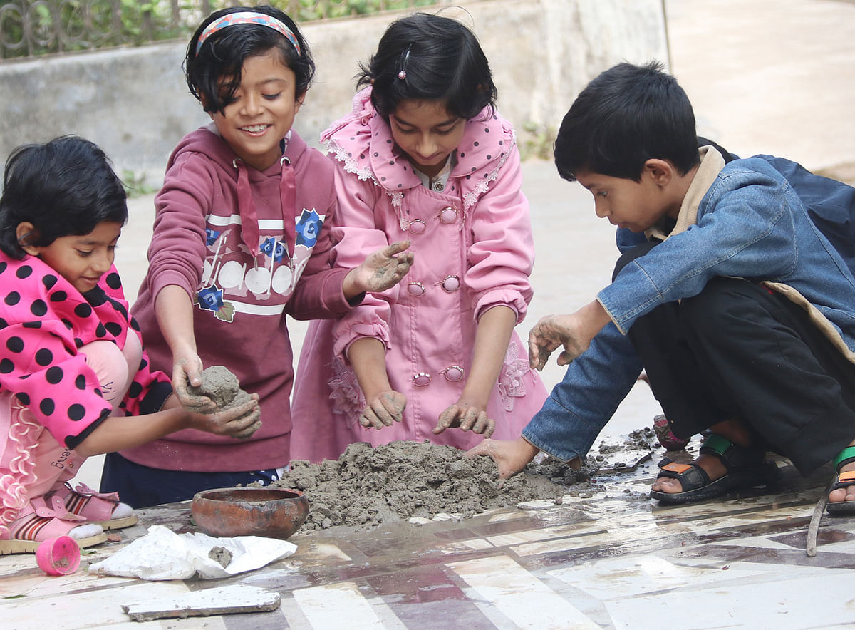 Children play with sand in the yard at Khorki, Jashore on 8 January 2019. Photo: Ehsan-ud-Doula