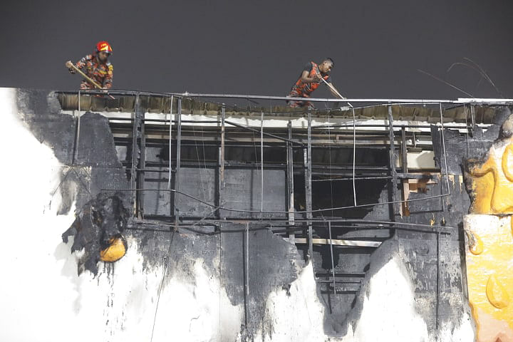 Firefighters work at Dhaka International Trade Fair (DITF) at Sher-e-Banglanagar on Thursday to blaze the fire. Photo: Dipu Malakar