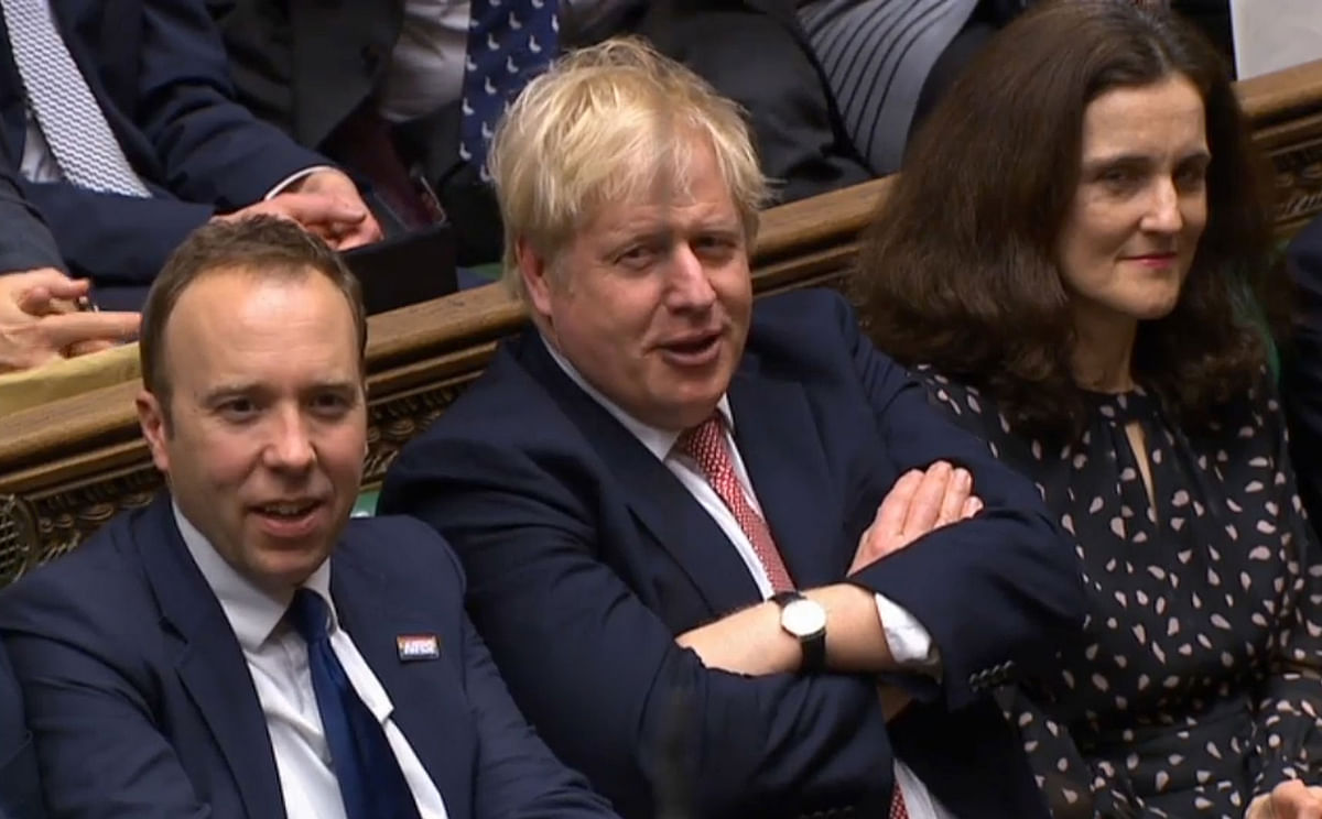 A video grab from footage broadcast by the UK Parliament`s Parliamentary Recording Unit (PRU) shows Britain`s Prime Minister Boris Johnson (C) reacting after his Government won the vote on the third reading of the European Union (Withdrawal Agreement) Bill, in the House of Commons in London on 9 January. Photo: AFP