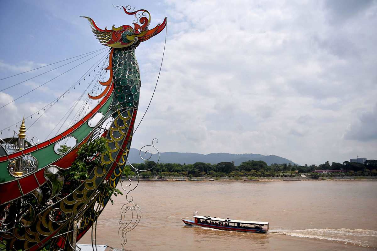 This picture taken on a9 September 2019 shows Chinese tourists taking a boatride along the Mekong River from the Thai side of the Golden Triangle, with the Laos side in the background, in Chiang Rai province. Photo: AFP