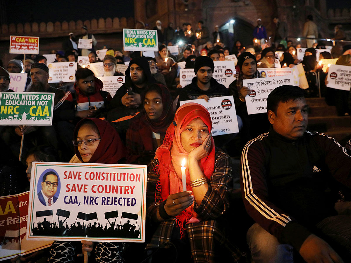 Demonstrators carry placards and hold candles during a silent protest against a new citizenship law at Jama Masjid, in the old quarters of Delhi, India, on 10 January 2020. Photo: Reuters