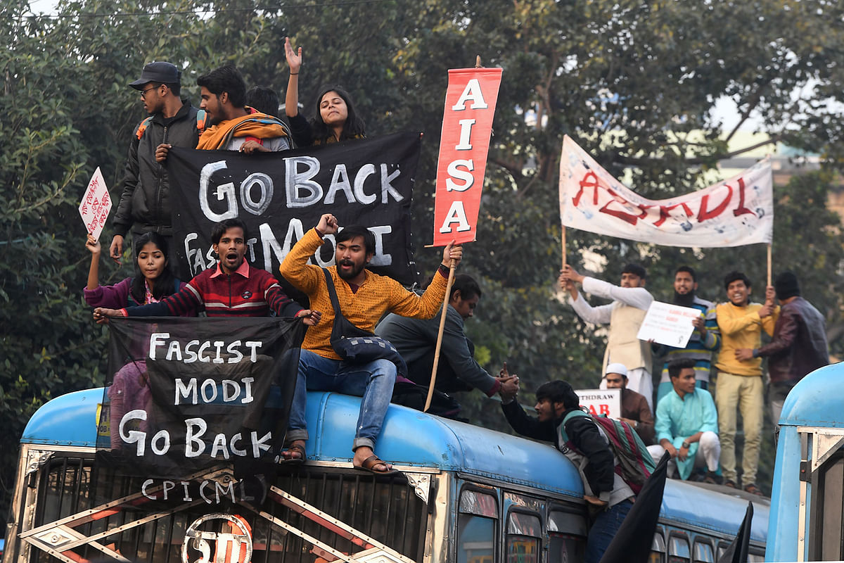 Activists hold placards and shout slogans against India`s prime minister Narendra Modi as they participate in a protest against India`s new citizenship law in Kolkata on 11 January, 2020. Photo: AFP