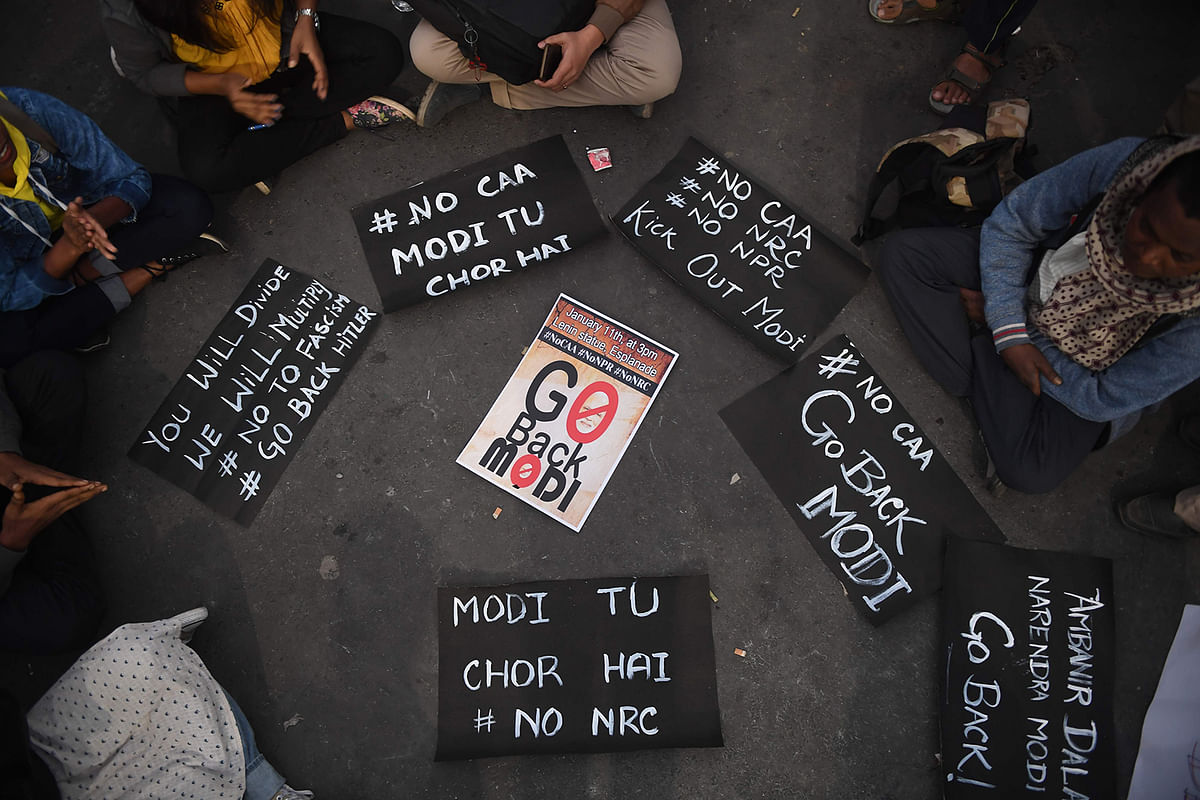 Placards are picture on the floor at a protest against India`s new citizenship law and the arrival of Indian prime minister Narendra Modi in Kolkata on 11 January, 2020. Photo: AFP