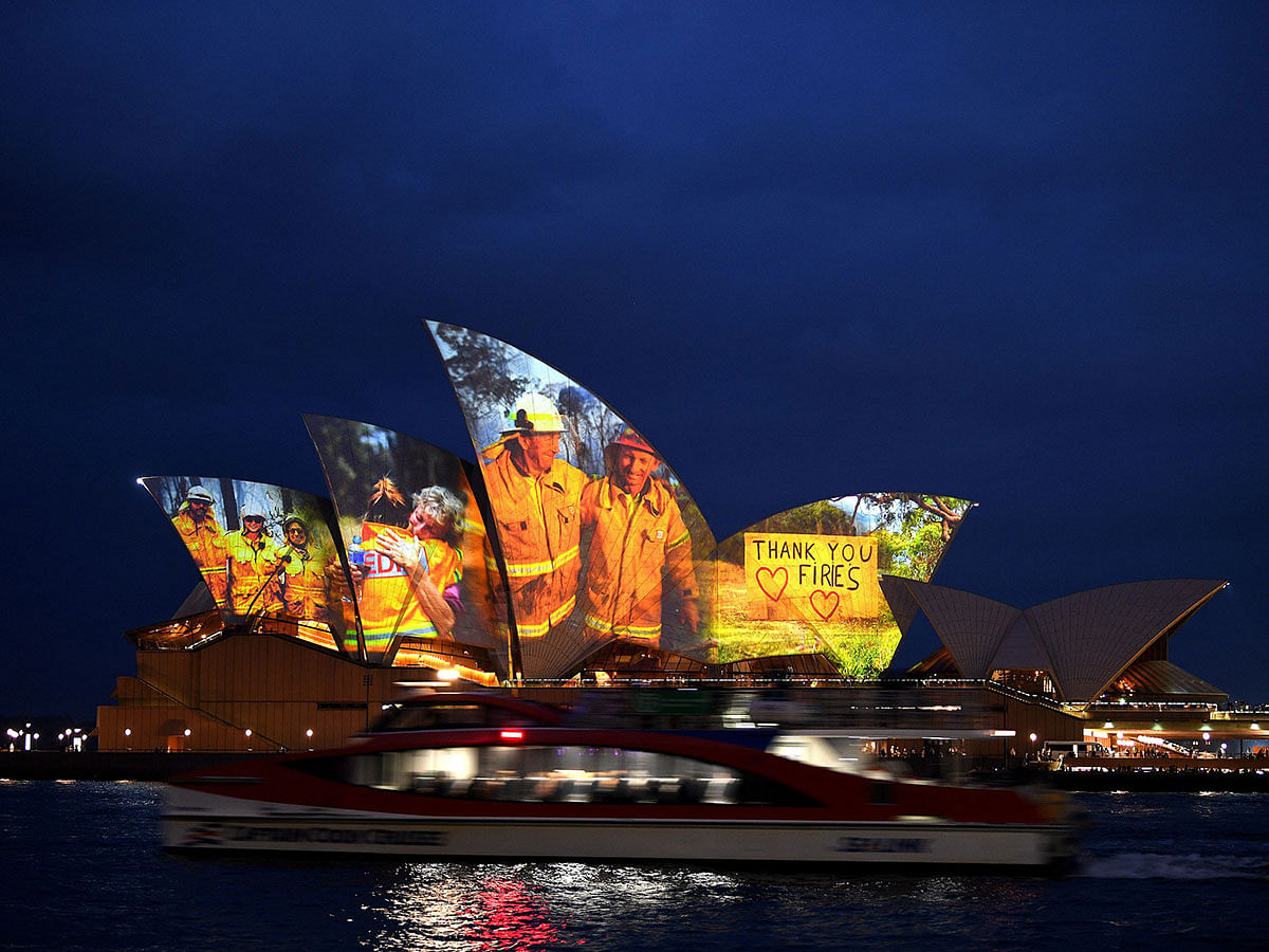 The sails of the Opera House are lit with a series of images to show support for the communities affected by the bushfires and to express the gratitude to the emergency services and volunteers in Sydney on 11 January 2020. Photo: AFP