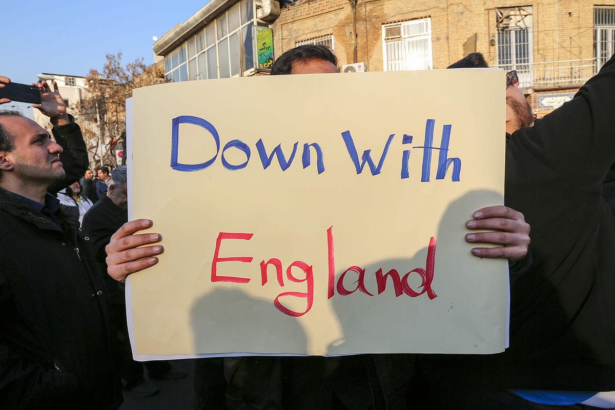 Iranian demonstrators hold placards bearing anti-Britain slogans in front of the British embassy in the capital Tehran on 12 January, 2020 following the British ambassador`s arrest for allegedly attending an illegal demonstration. Photo: AFP