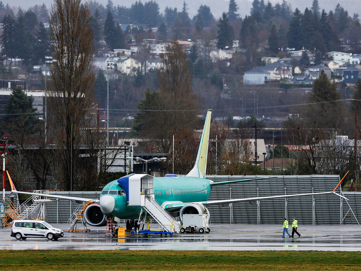 Employees walk near a Boeing 737 Max aircraft at the Renton Municipal Airport in Renton, Washington, US on 10 January. Photo: Reuters