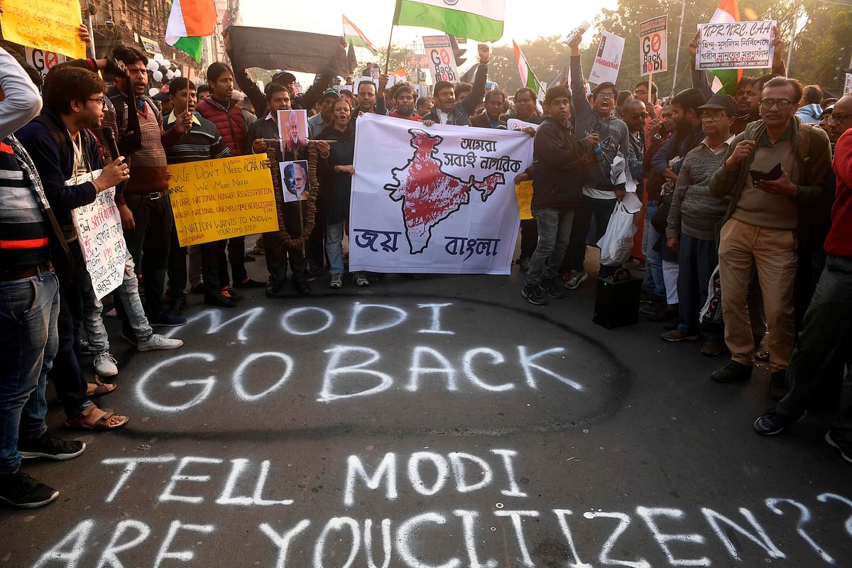 Protesters hold placards and shout slogans against Inida`s prime minsiter Narendra Modi as they participate in a protest against India`s new citizenship law, in Kolkata on 11 January 2020. Photo: AFP