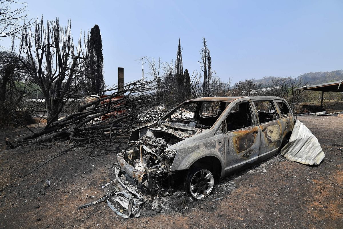 A burnt car is seen after bushfire in Batlow, in Australia`s New South Wales state on 8 January 2020. Photo: AFP