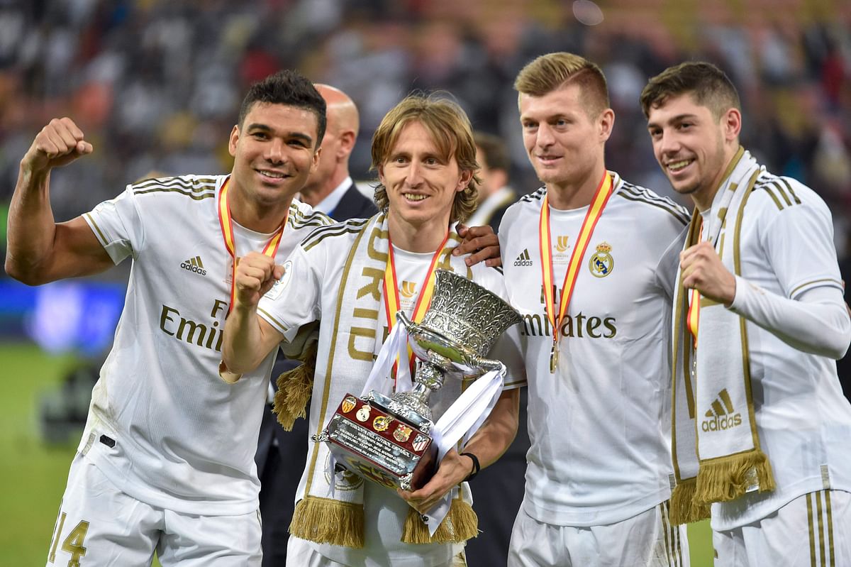 Real Madrid`s Brazilian midfielder Casemiro, Real Madrid`s Croatian midfielder Luka Modric, Real Madrid`s German midfielder Toni Kroos and Real Madrid`s Uruguayan midfielder Federico Valverde pose with the trophy after winning the Spanish Super Cup final between Real Madrid and Atletico Madrid on 12 January, 2020, at the King Abdullah Sports City in the Saudi Arabian port city of Jeddah. Photo: AFP