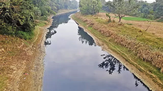 Water of Tulsi Ganga river turns pitch black killing fishes, hampering irrigation. This photo is taken from Nawabganj bridge. Photo: Prothom Alo