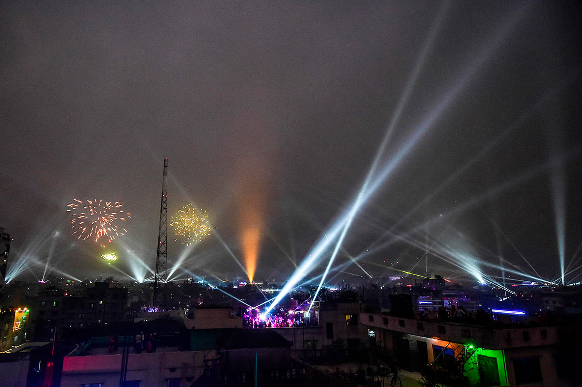 Youth celebrate with fireworks and lights during the Shakrain festival or the Kite festival in Dhaka on 14 January 2020. Photo: AFP