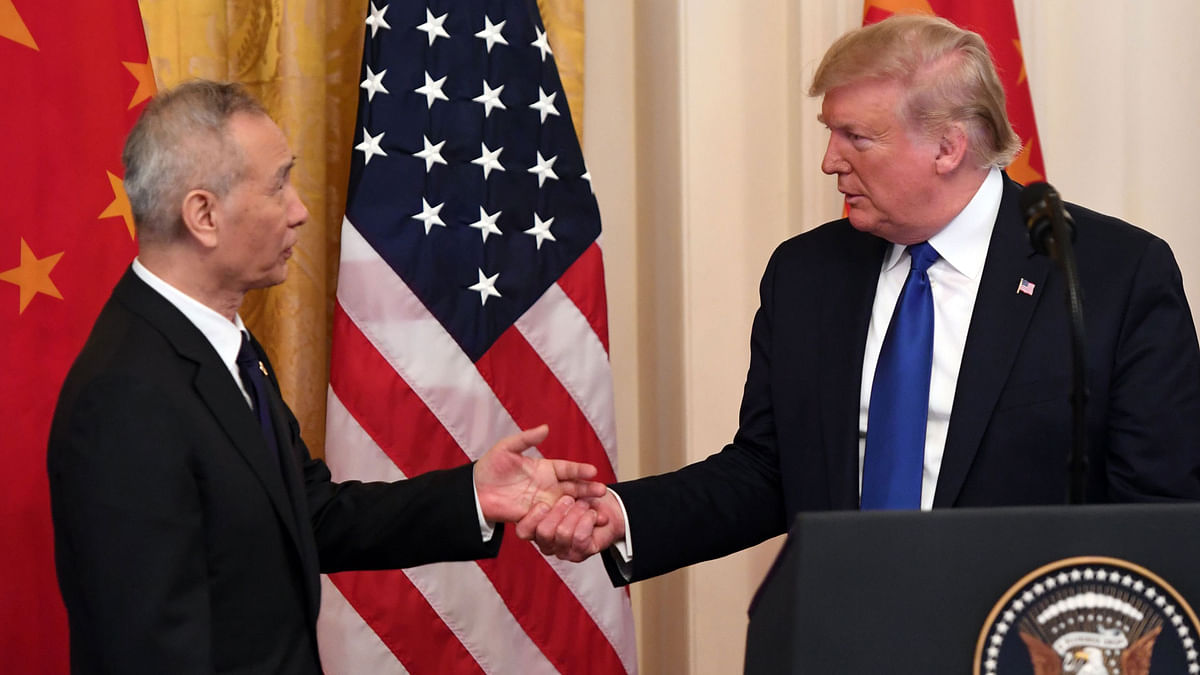 US president Donald Trump, shakes hands during a press conference with China’s vice premier Liu He(L), the country’s top trade negotiator, before they sign a trade agreement between the US and China during a ceremony in the East Room of the White House in Washington, DC on 15 January 2020. Photo: AFP