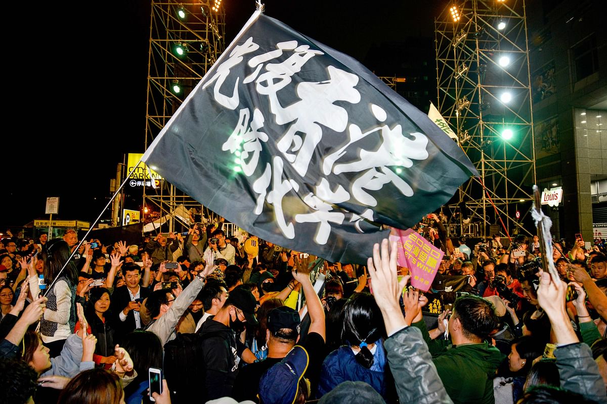 Supporters celebrate the poll victory of Taiwan`s President Tsai Ing-wen and chant slogans in support of pro-democracy protesters in Hong Kong, outside the Democratic Progressive Party`s headquarters as results came in for the general election in Taipei on 11 January. Photo: AFP