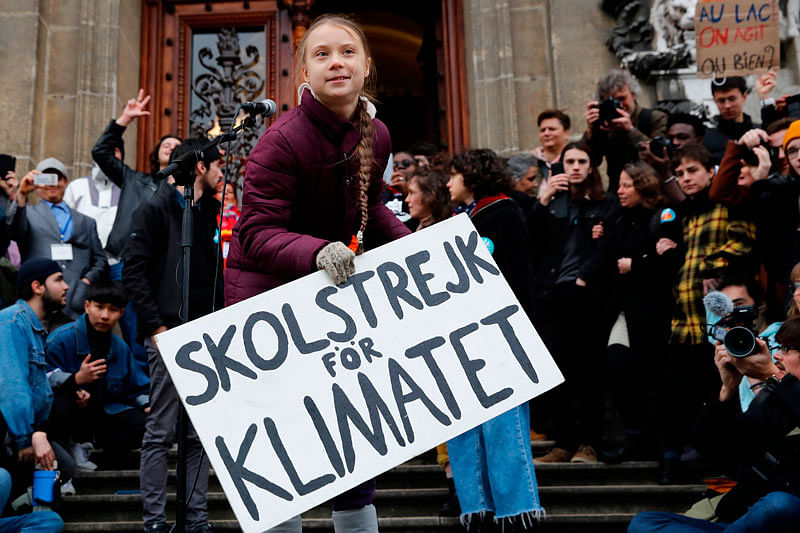 17-year-old Swedish climate activist Greta Thunberg (C) speaks next to a placard reading `School strike for Climate` during a climate strike against governmental inaction towards climate breakdown and environmental pollution in Lausanne, on 17 January, 2020. Photo: AFP