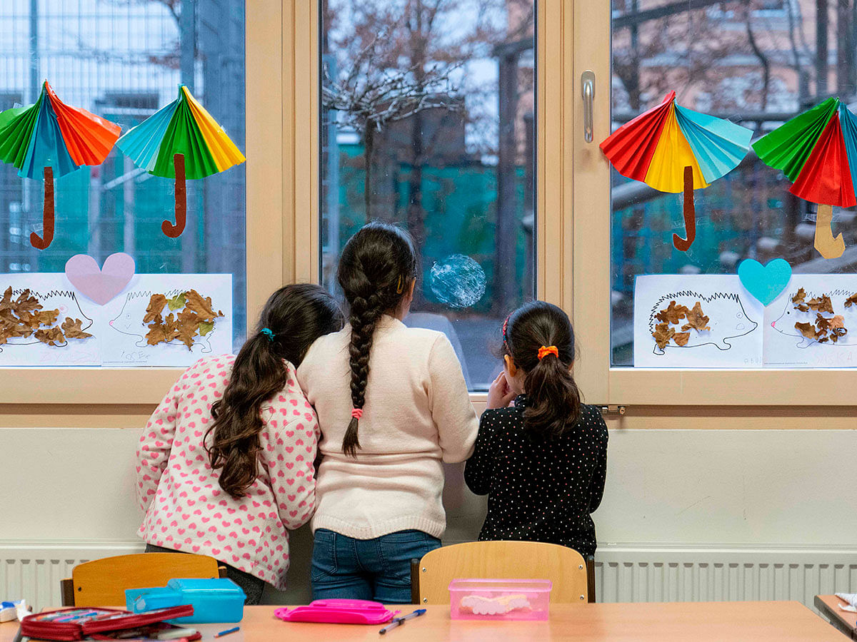 Girls take a brake during a special German language class for recently arrived migrant children at Felbigergasse elementary school in Vienna, Austria on 3 December 2019. Photo: AFP
