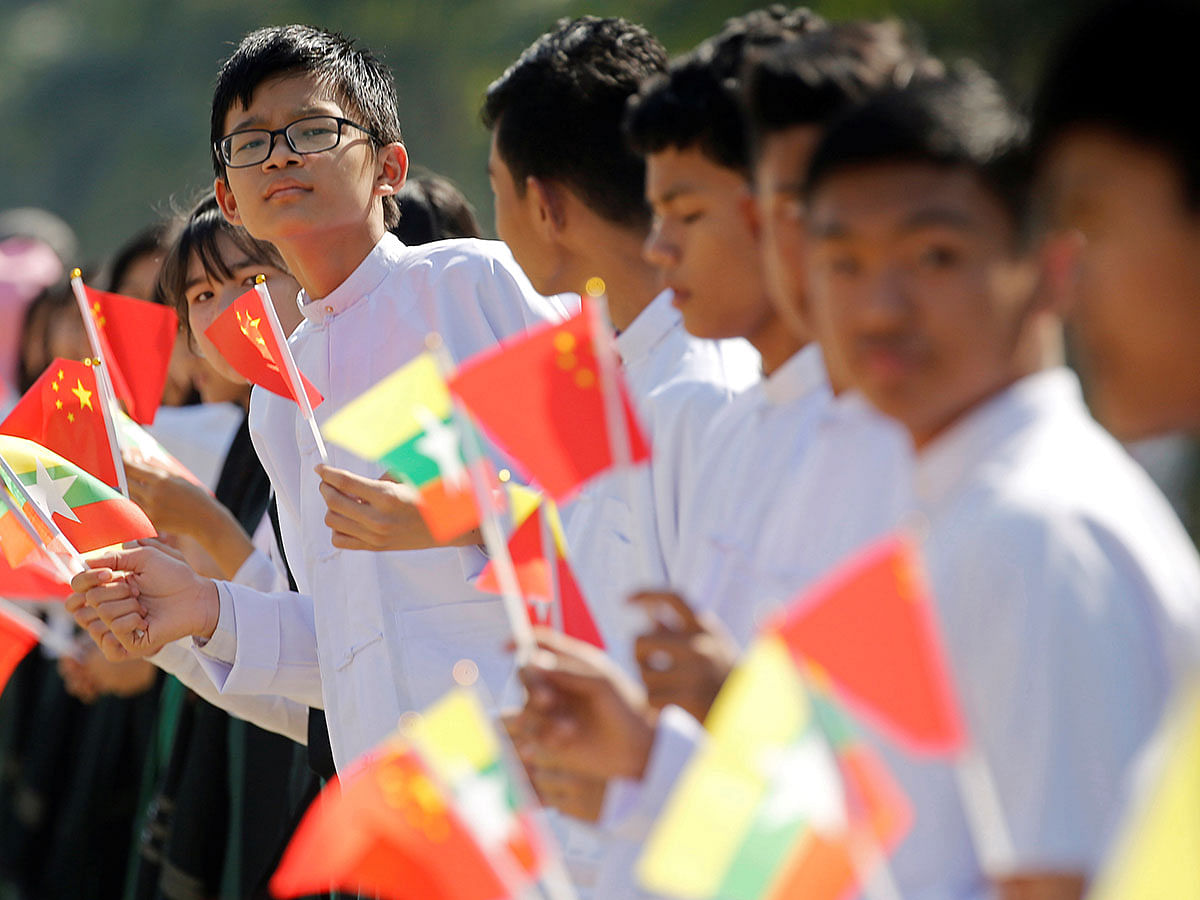 Myanmar students hold Myanmar and Chinese flags as they prepare to welcome Chinese president Xi Jinping outside of the airport in Naypyitaw, Myanmar, on 17 January 2020. Photo: Reuters