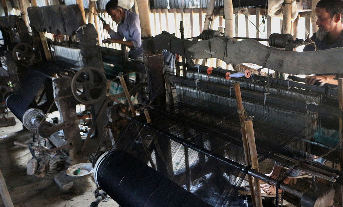Craftsmen weave cotton fabric on their looms. This fabric is sent to different parts of the country including Narayanganj. The photo is taken from Arihazar of Narayanganj on 18 January. Photo: Dinar Mahmud.