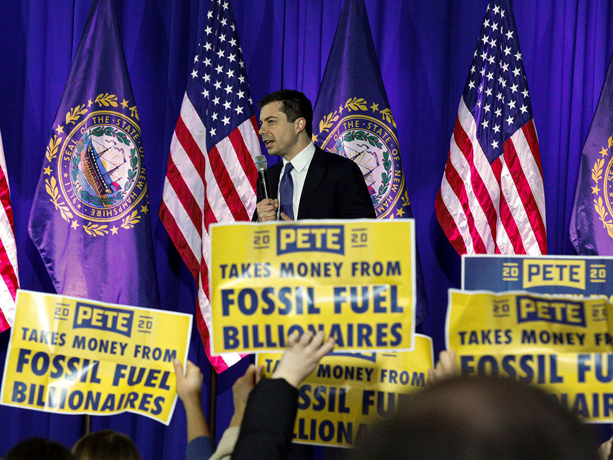 Climate change activists hold signs as they disrupt a campaign town hall meeting with Democratic 2020 US presidential candidate and former South Bend Mayor Pete Buttigieg in Concord, New Hampshire, US on 17 January. Photo: AFP