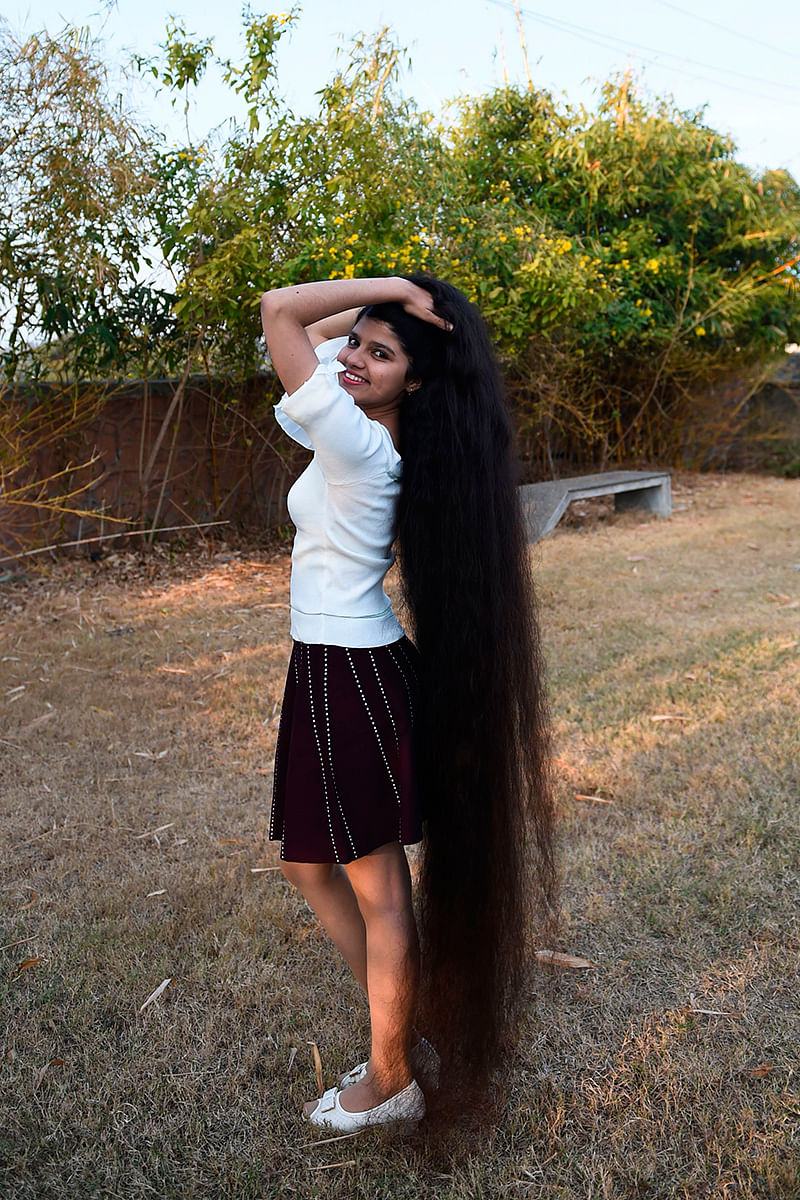 Nilanshi Patel, 17, who has been awarded the 2019 Guinness World Record for the longest hair in the teenager category, 190 cm, poses for a picture at Modasa town, some 110 Kms from Ahmedabad on 19 January 2020. Photo: AFP