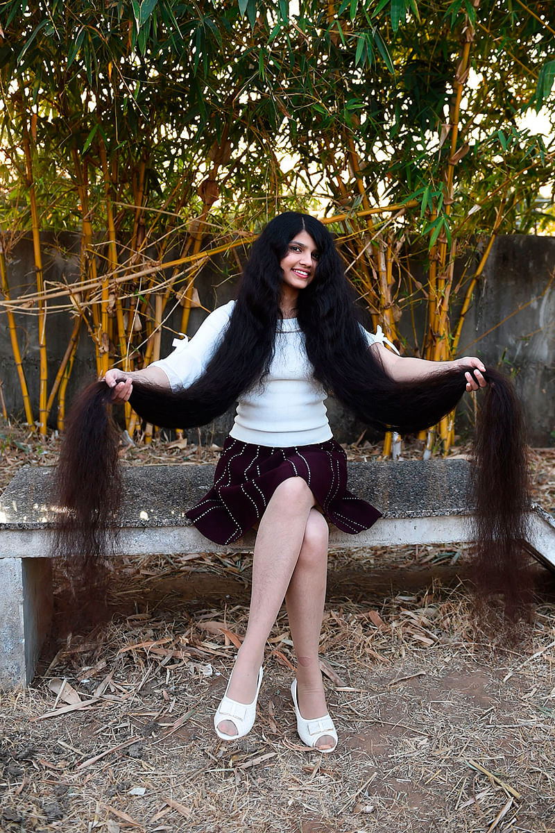 Nilanshi Patel, 17, who has been awarded the 2019 Guinness World Record for the longest hair in the teenager category, 190 cm, poses for a picture at Modasa town, some 110 Kms from Ahmedabad on 19 January 2020. Photo: AFP