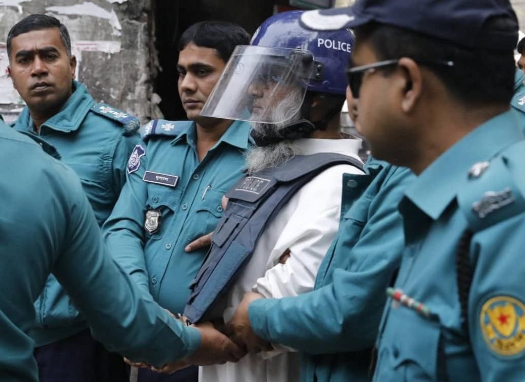 Police escort the defendants in CPB bombing case to the additional metropolitan magistrate`s court in Dhaka on 20 January 2020. Photo: Dipu Malakar -5e25427a04afe