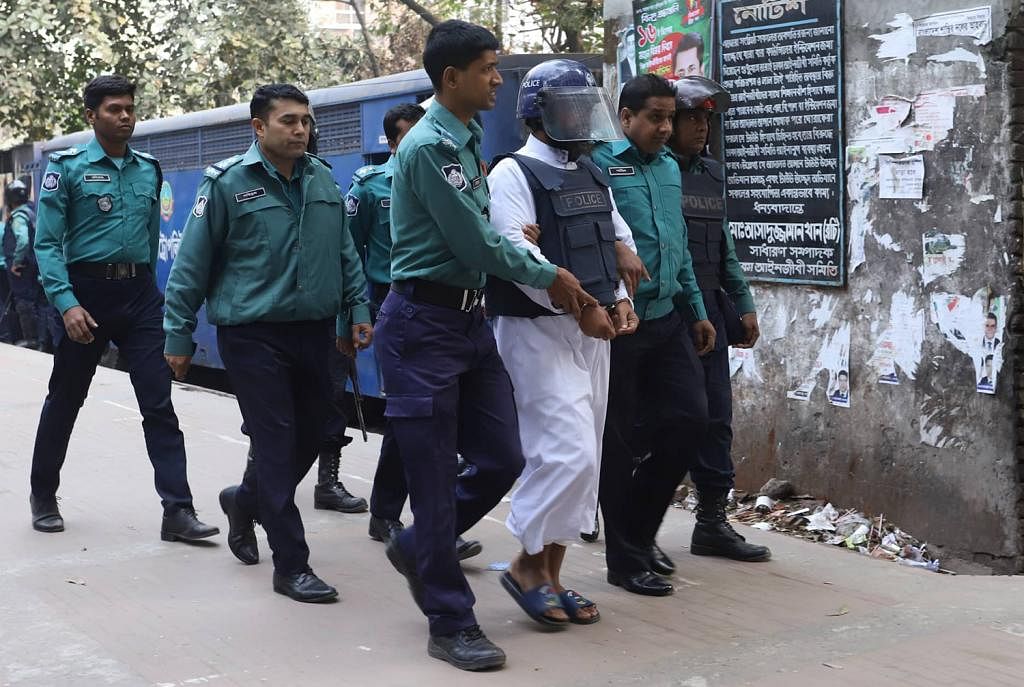 Police escort the defendants in CPB bombing case to the additional metropolitan magistrate`s court in Dhaka on 20 January 2020. Photo: Dipu Malakar