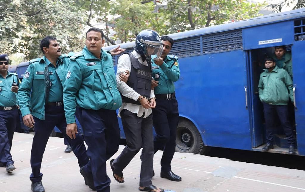 Police escort the defendants in CPB bombing case to the additional metropolitan magistrate`s court in Dhaka on 20 January 2020. Photo: Dipu Malakar