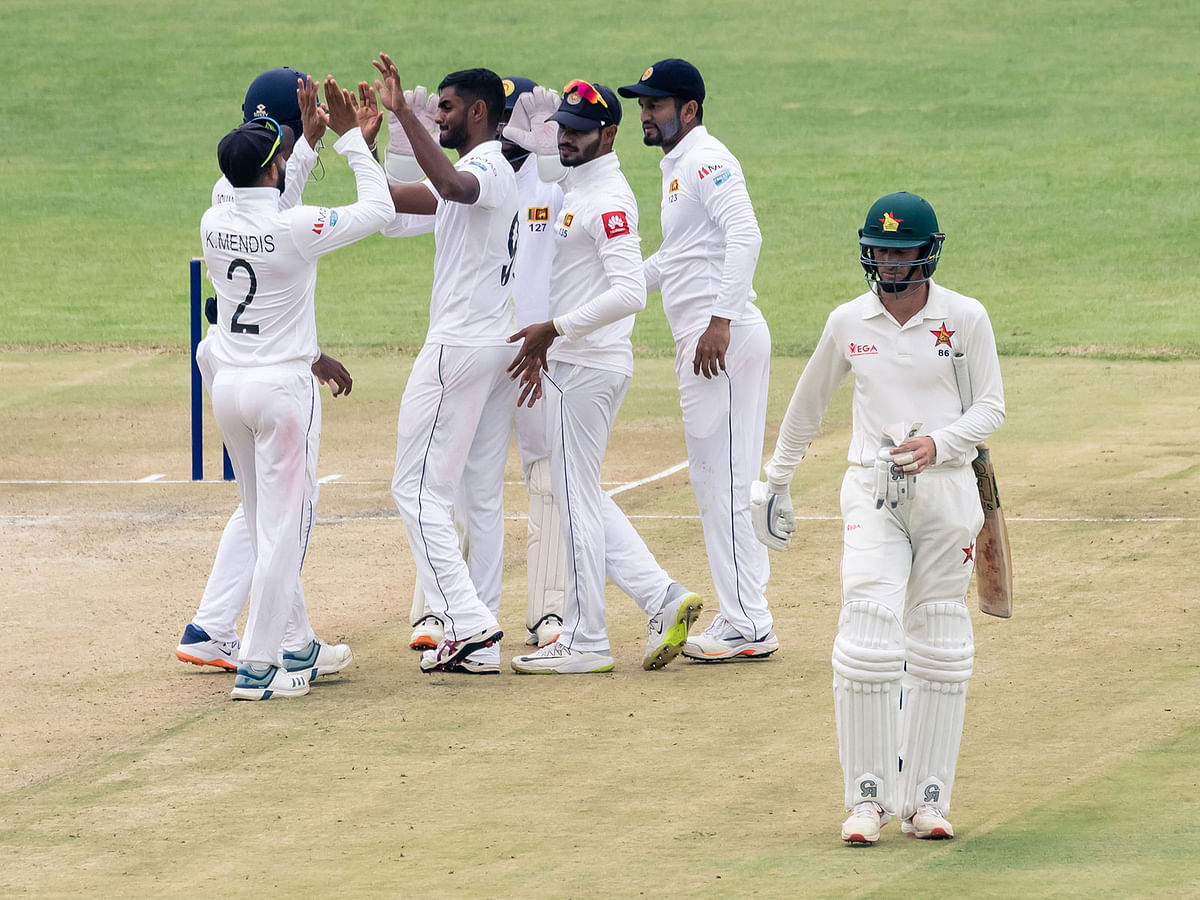 Zimbabwe`s captain Sean Williams (R) walks back to the pavilion after his dismissal by Sri Lanka`s Lasith Embuldeniya while the Sri Lanka tem celebrates during the second day of the first Test cricket match between Zimbabwe and Sri Lanka at the Harare Sports Club in Harare on 20 January 2020. Photo: AFP